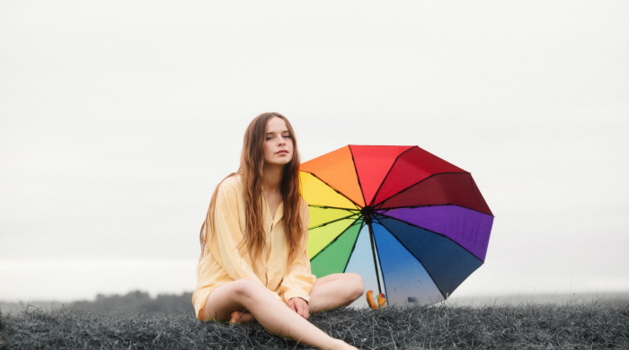 Artist Gabrielle Aplin with a rainbow umbrella
